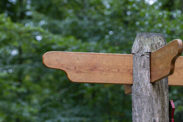 pole with wooden sign for direction outdoors in nature