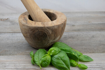 Mortar and pestle with basil leaves