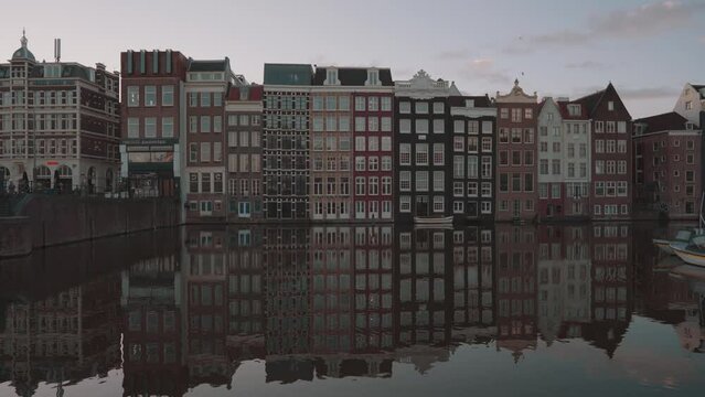 Amsterdam, Netherlands - Dancing Houses on Damrak Canal in the Morning