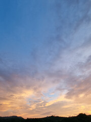 cloud and vanilla sky background with dark mountain silhouette