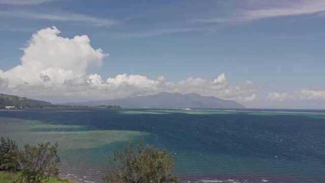Ariel View of Tahitian Beach with Coconut Grove and Rugged Mountains of Tahiti Iti in the Distance