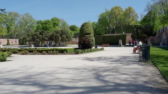 View of "Parque del Retiro" (Retirement Park) with people walking around and enjoying a beautiful sunny day in Madrid, Spain.