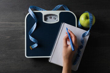 Concept of weight loss and healthy nutrition with apple and measuring tape