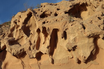 Erosion that forms crevices in a roadside cliff