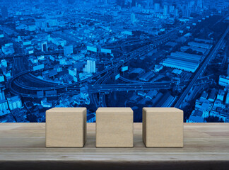 White block cube on wooden table over modern office city tower and skyscraper