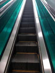 An escalator going up without anyone.