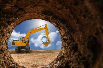 Crawler excavator are digging soil in the tunnel construction site. With a  sun on blue sky...