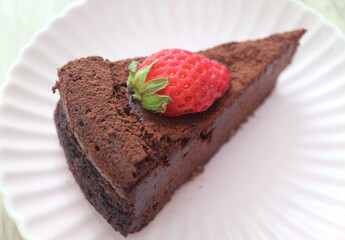 Delectable Flourless Chocolate Cake or Torta Caprese Topped with Fresh Strawberry