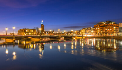 Fototapeta na wymiar Illuminated Cityscape in blue hour in Stockholm with a City Hall in the background