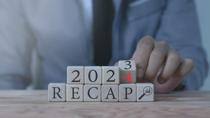 Business finance concept, economic summary 2023, business plan 2024, words RECAP 2023 and 2024 on...