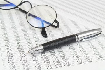 Black glasses and pen on financial  papers. Business concept. 