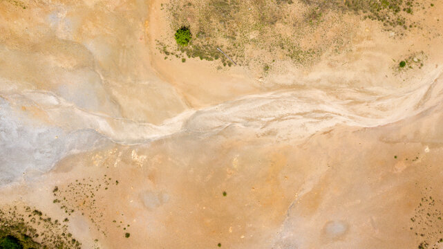 Aerial view of a dried up river in a desert area. Effects of climate change and global warming.