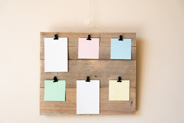 wooden board with clips on which to hang coloured post it notes, note board on which to put reminders and things to do in the office or at home.