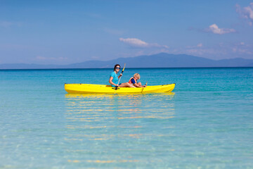 Fototapeta na wymiar Kids kayaking in ocean. Family in kayak in tropical sea