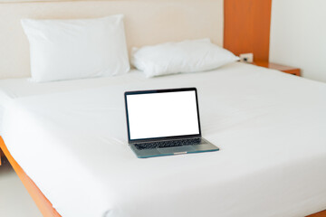 Laptop on empty bed,Caucasian woman laying on bed using laptop