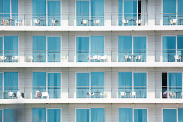 Plastic chairs on the balconies of a multi-storey building