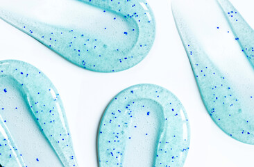 smears round drop of peeling gel test sample of scrub cosmetics on a white background