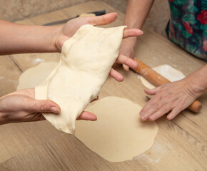 Hands of women kneading dough for dumplings