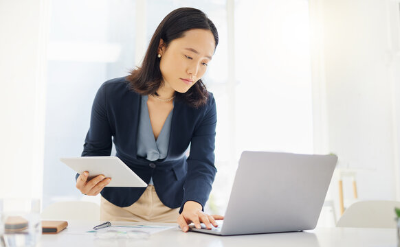 Tablet, focus and laptop with business woman in office for planning, online report and email. Technology, communication and connection with asian female employee for corporate, idea and review
