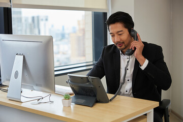 operator or businessman using telephone and talking with customer at call center service in the office