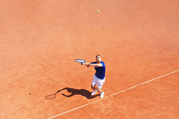 Tennis Player Serving on a Clay Court - 597051315