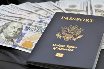 US passports next to a stack of US dollar banknotes. US document. Business.