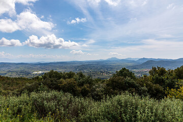Fototapeta na wymiar A beautiful landscape of the island of Corfu in the Ionian Sea in Greece. Mountains with plenty of green vegetation. Thick clouds over the island. 