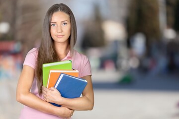 Fototapeta premium Pretty young woman university student with books