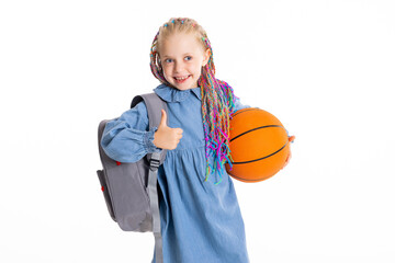 Happy adorable smiled girl with colorful braids shows thumb up holds basketball ball in hand wears...