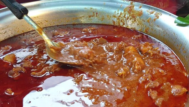 Shop selling hang lay hung leah pork belly curry in Northern Thailand local market take home hot food in plastic bag