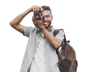 Young man photographer takes photographs with dslr camera isolated in transparent PNG. Travel, hobby, vacations, professional freelance work and active lifestyle concept