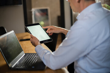 Close up of man using digital tablet.