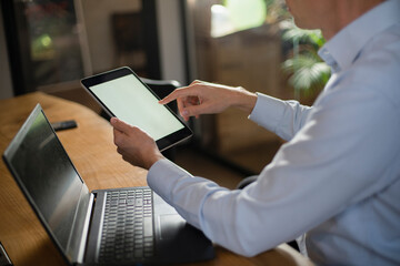 Close up of man using digital tablet.