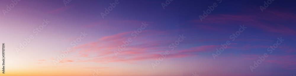 Wall mural panorama of heavens at dawn. clouds in red and orange colors of a rising sun on a blue sky