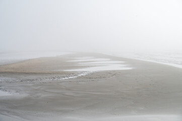 Fog on Baltic sea coastline at spring. Moody weather, mist