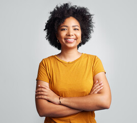 Happy, woman and arms crossed for portrait in studio, white background and backdrop. Young female...