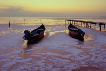 wooden boats on frozen lake in winter 01