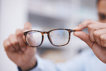 Optometry, hands and optician with glasses for choice, eyesight and frame decision. Giving, showing and a man holding prescription eyewear for a fitting, vision and service during a consultation