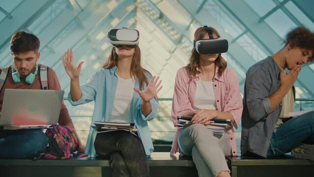 Group of Happy University Students Using Virtual Reality Glasses or VR Headset Together in College Hallway. Science and Technology Subject. Interactive Experience: Students in VR. New Way of Learning
