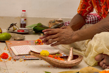 A hindu priests offering milk to Shiva linga on the occasion of an individual's first time entering their new home. Graha Pravesh entering the new home.