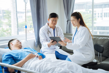 Fototapeta premium Accident, health and people concept. Doctor talking to male patient on hospital bed.