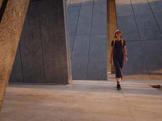 travel to the United Arab Emirates, Happy young asian female traveler with backpack and hat in Wahat Al Karama or Oasis of Dignity, permanent memorial for its martyrs, and Shaikh Zayed Grand Mosque.