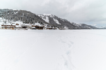 Snowfall in Sauris. Among the woods and historic houses.