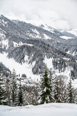 Snowfall in Sauris. Among the woods and historic houses.