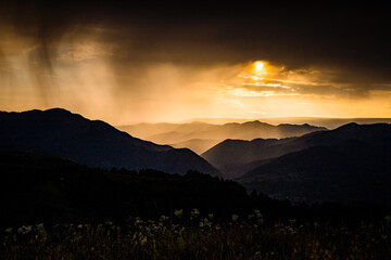 banner of mountain peaks in beautiful stormy sunset light