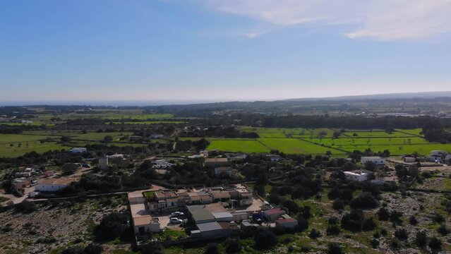 Drone manouevering on Formentera with view over reen fields.