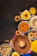 Festa Junina Summer Festival Carnival concept. Brazilian straw hat, popcorn, peanuts and Corn Cake on Wooden Background for Brazilian Festa Junina Summer Festival