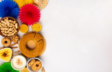 Festa Junina Summer Festival Carnival concept. Brazilian straw hat, popcorn, peanuts and Corn Cake on White Wooden Background