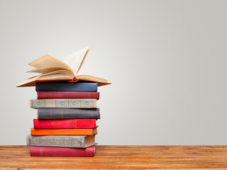 Pile of books on wooden table with copy space. Education background