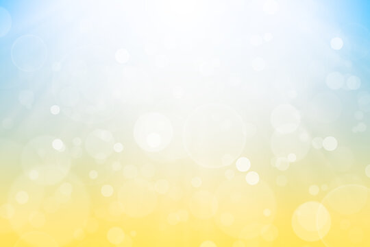 Abstract background with bokeh and defocused lights in yellow and blue colors
